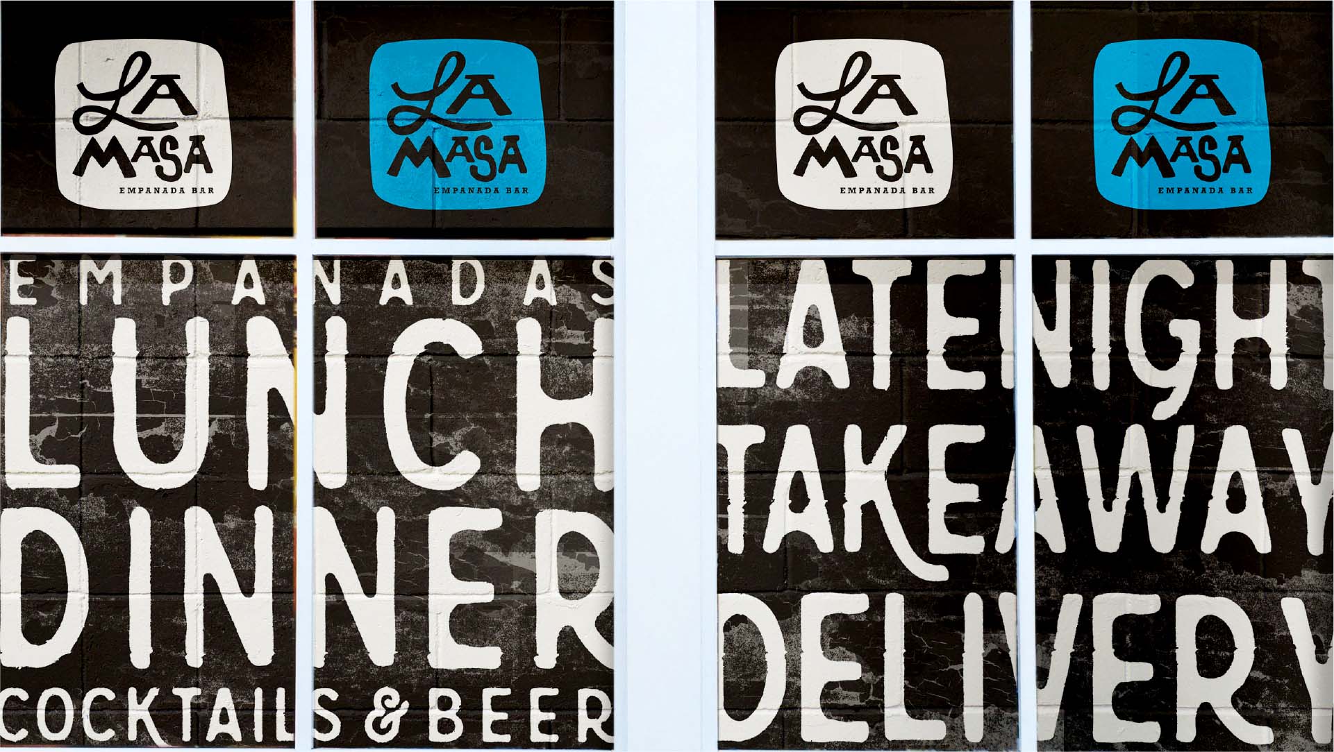 La Masa logos painted on bricks in dark black, rich bright blue, and white along with brief take aways of available items and services painted black and white on a brick wall. Items include Lunch, Dinner, Cocktails, and Beer, among others.